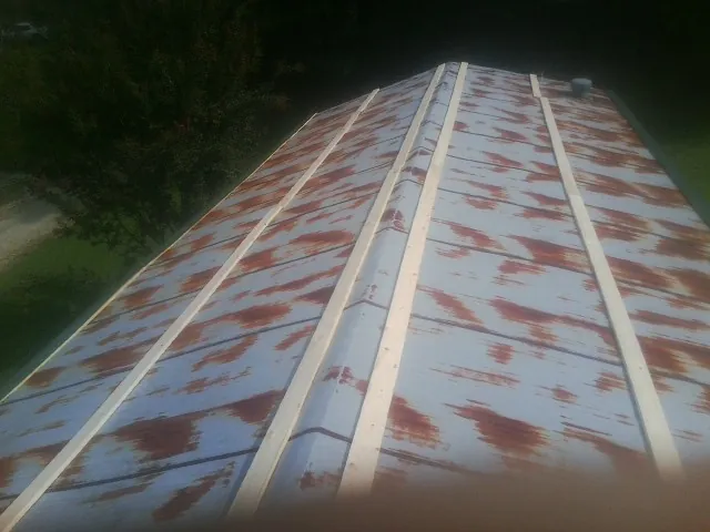 Rusted metal roof panels with new wood purlins before replacement — Storm Damage Roof Repair in Gambier by Roofing Brothers